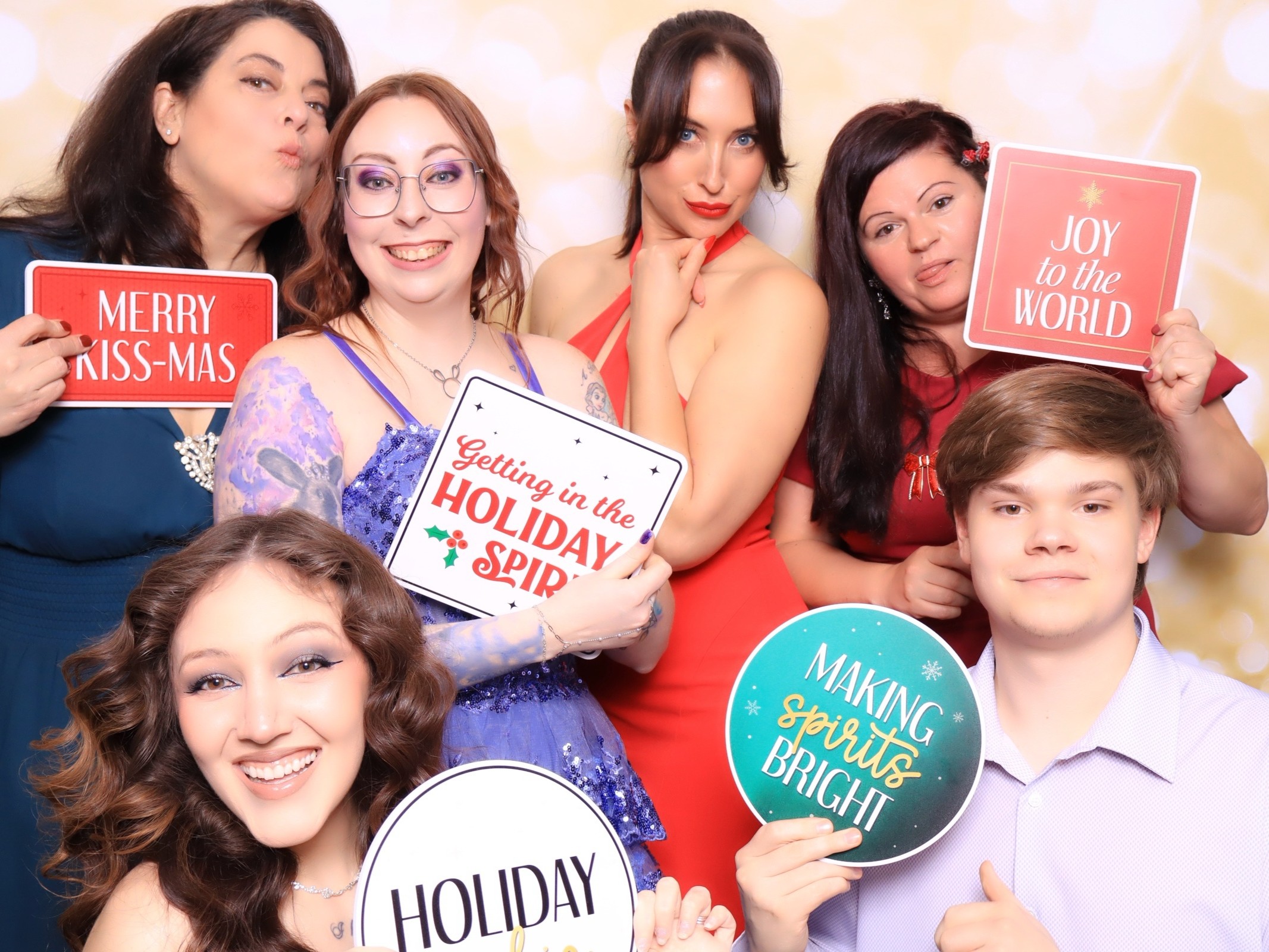 Team members laughing during a luxury open-air photo booth session at a company holiday party