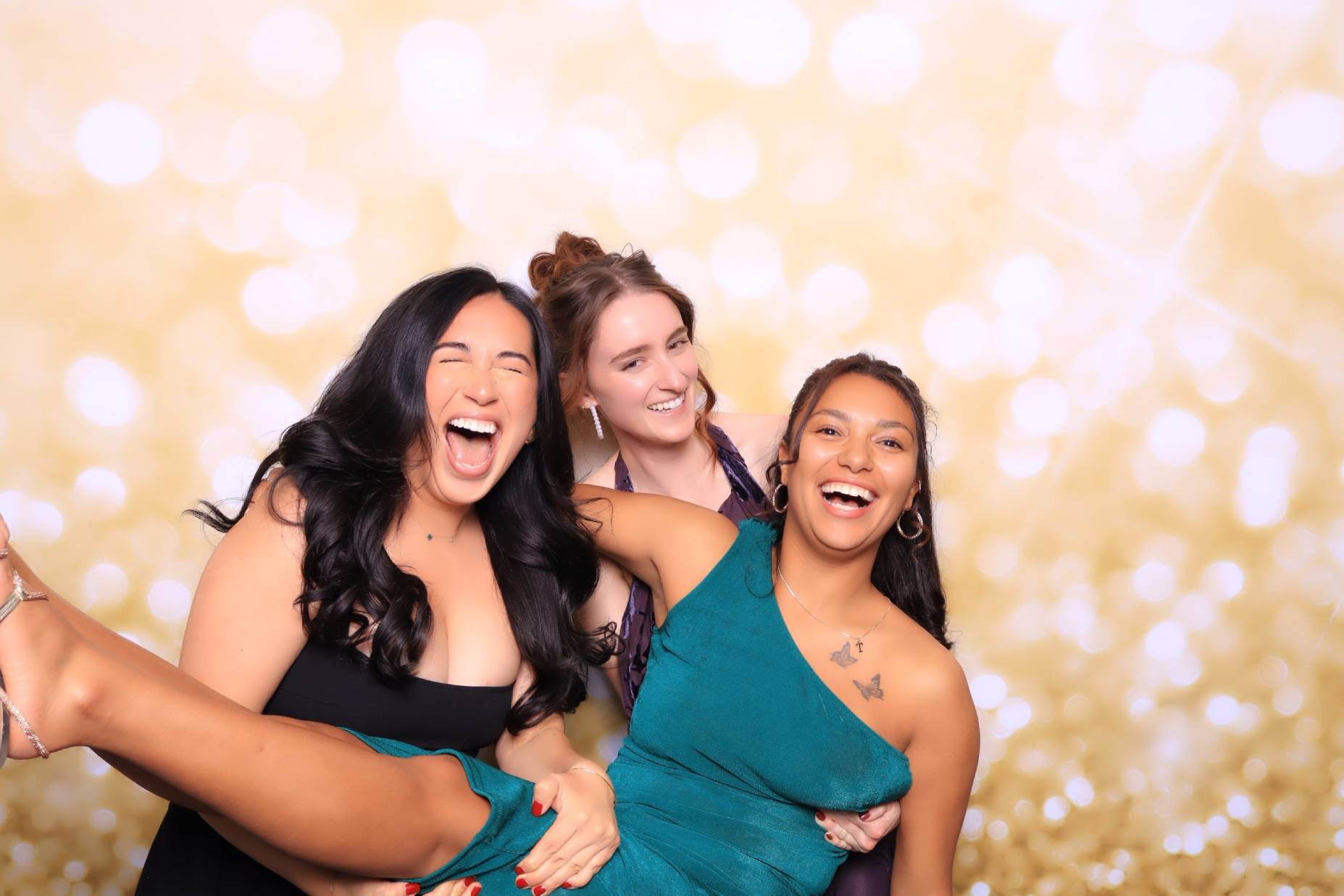 Friends having fun in a luxury photo booth at a colorado springs wedding