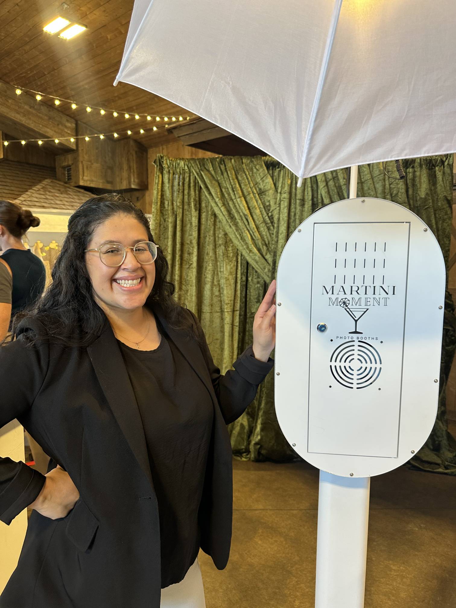Karla, founder of Martini Moment Photo Booths, smiling while sharing her passion for capturing unforgettable wedding and event memories