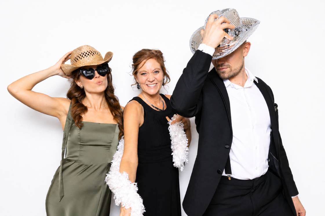 Guest holding a personalized photo keychain made live at a Martini Moment Photo Booth event