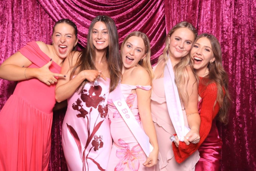 brides and bridesmaids at cheers using martini moment photo booths at hotel polaris