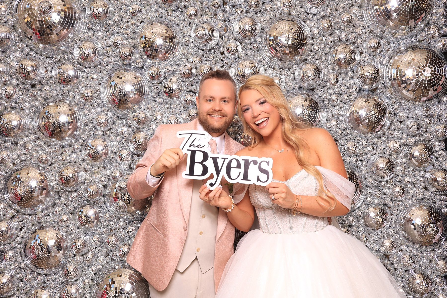 bride and groom posing in luxury photo booth in estes park 