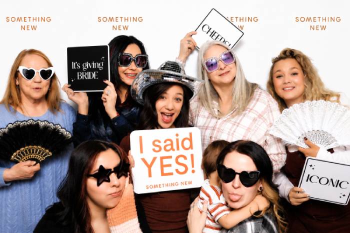 Bride and bride crew at something new in colorado springs using martini moment photo booth rental