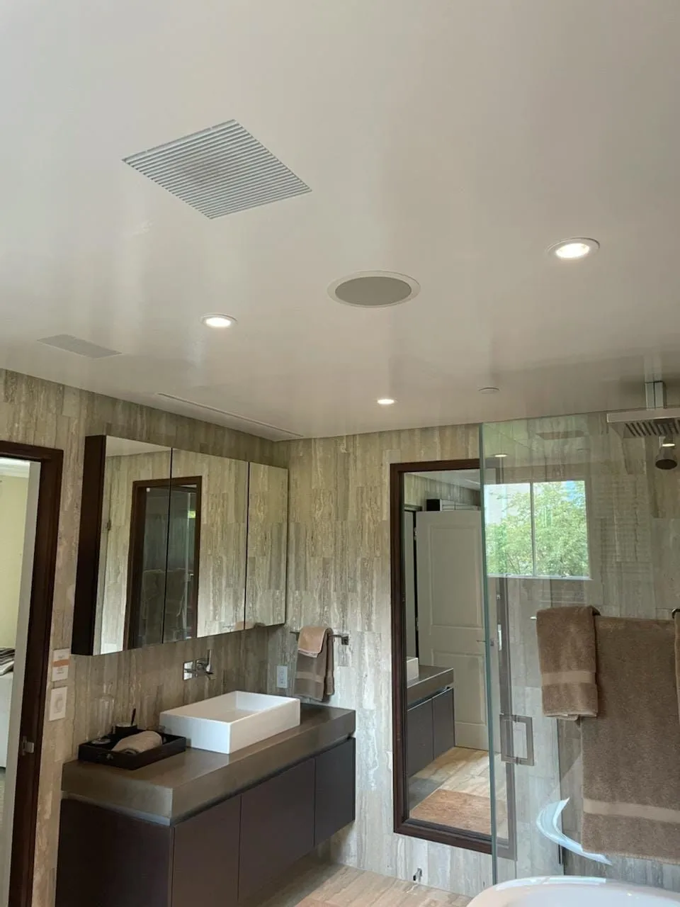 Spa-inspired master bathroom with walk-in wet room and freestanding tub