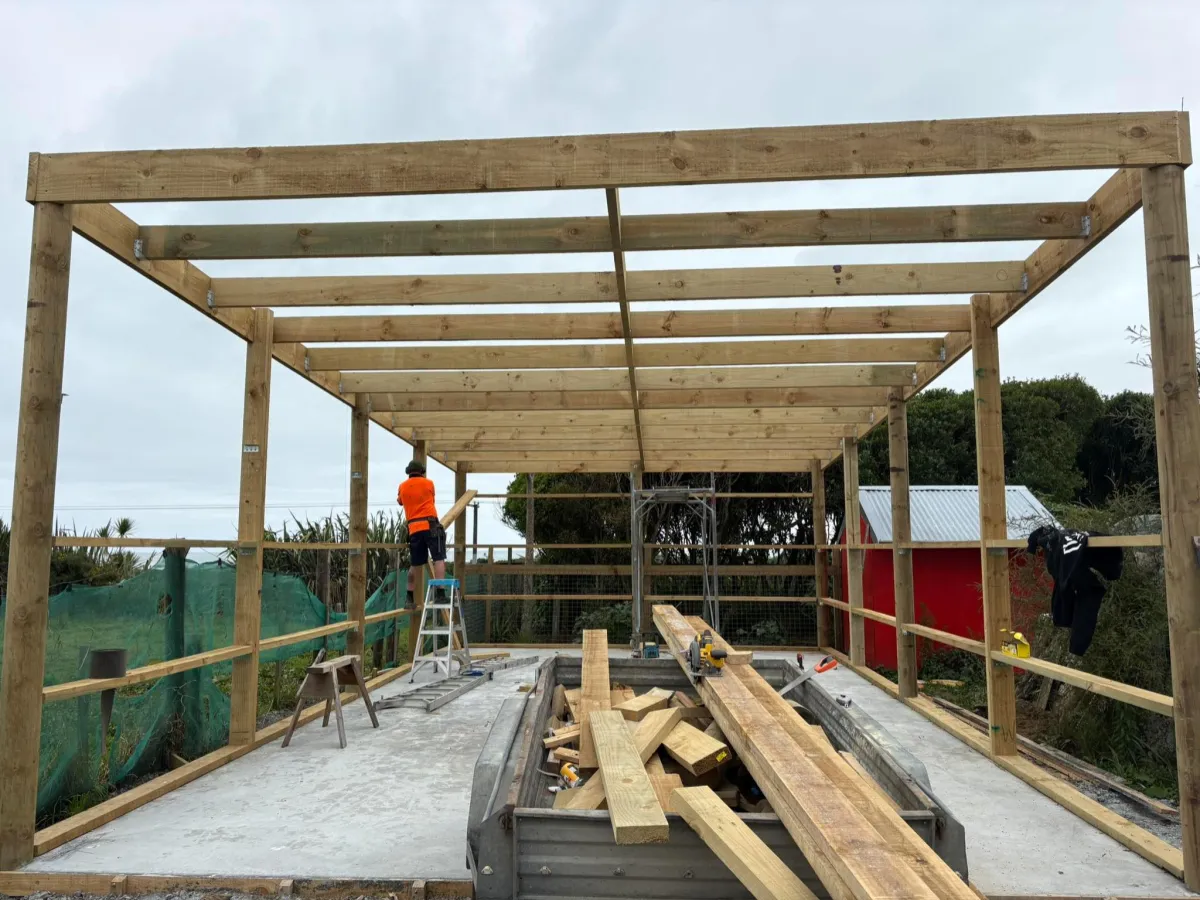 Pole shed frame under construction by licensed builder West Coast NZ