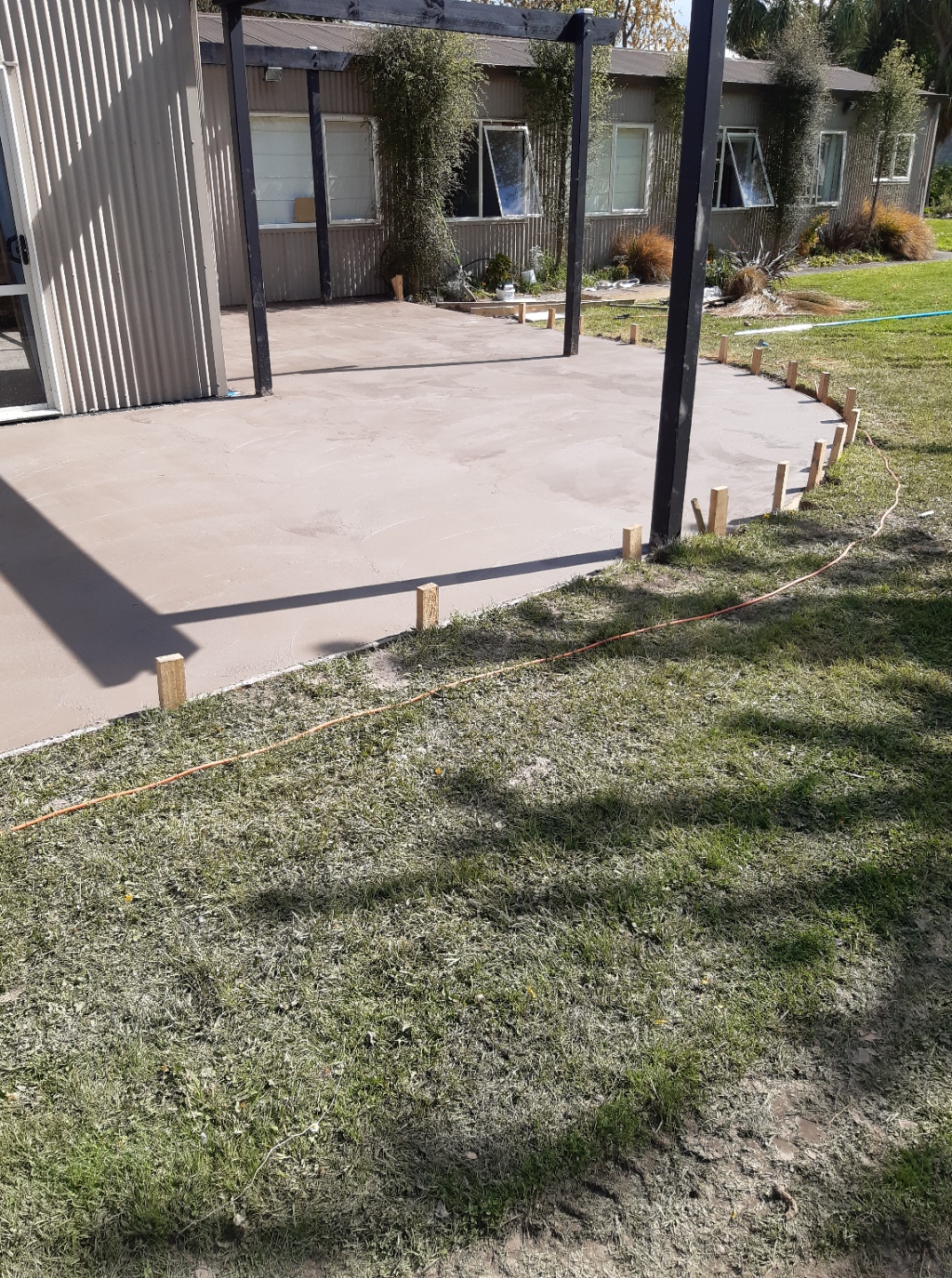 New concrete driveway and path at a Methven home by Opuke Small Builds