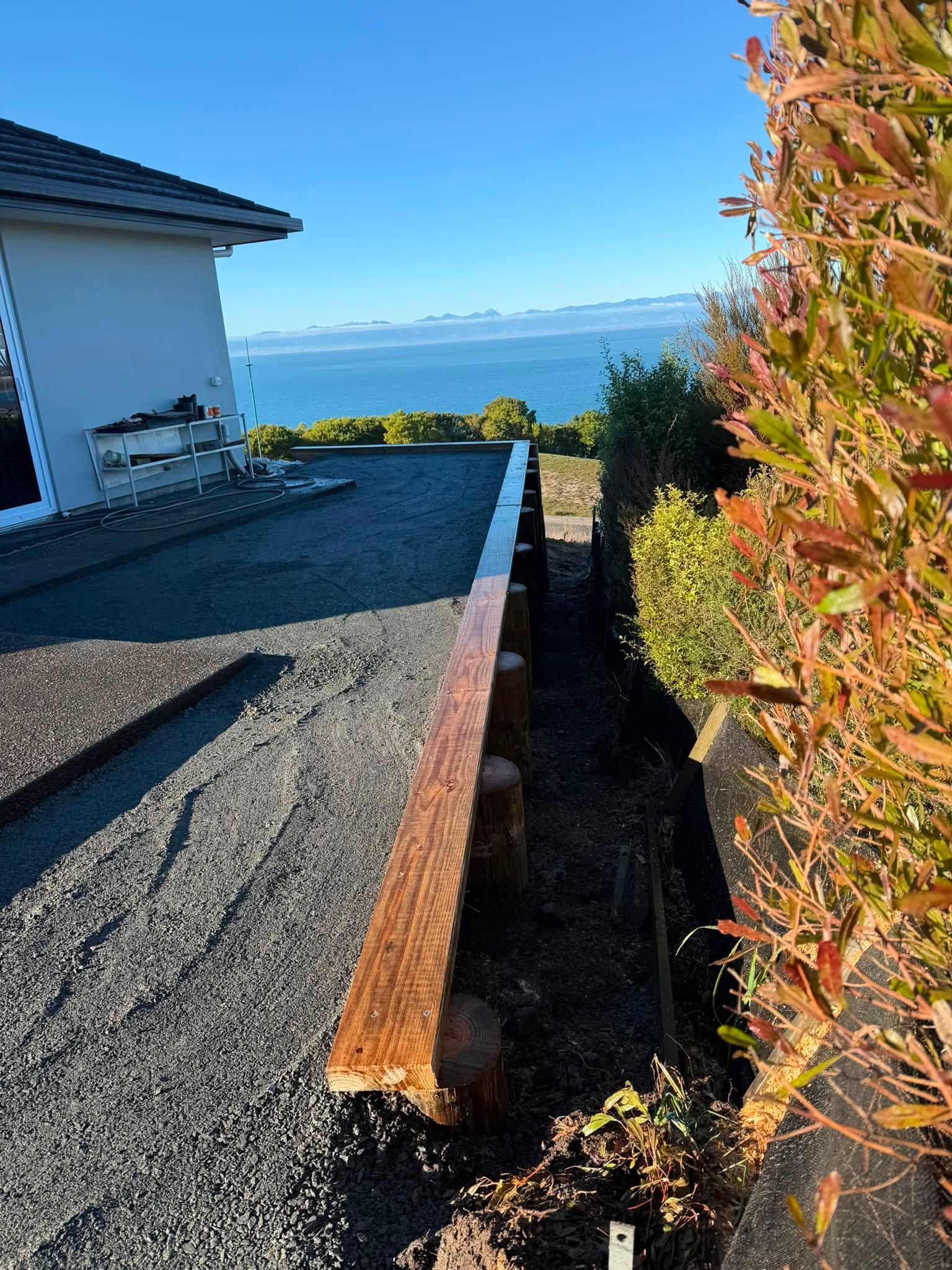 Timber retaining wall with sea views levelled site Nelson