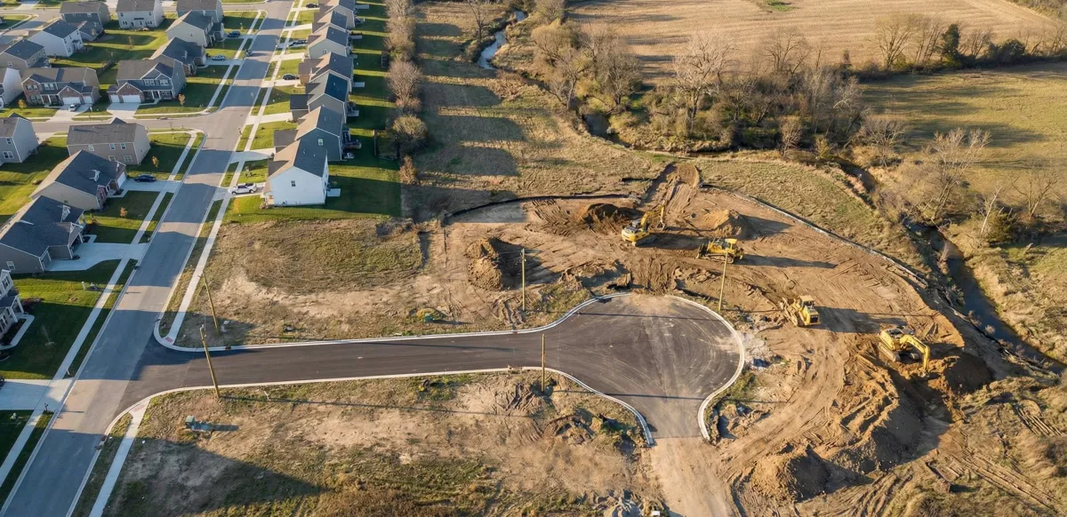 a modern house with a pool and lounge chairs