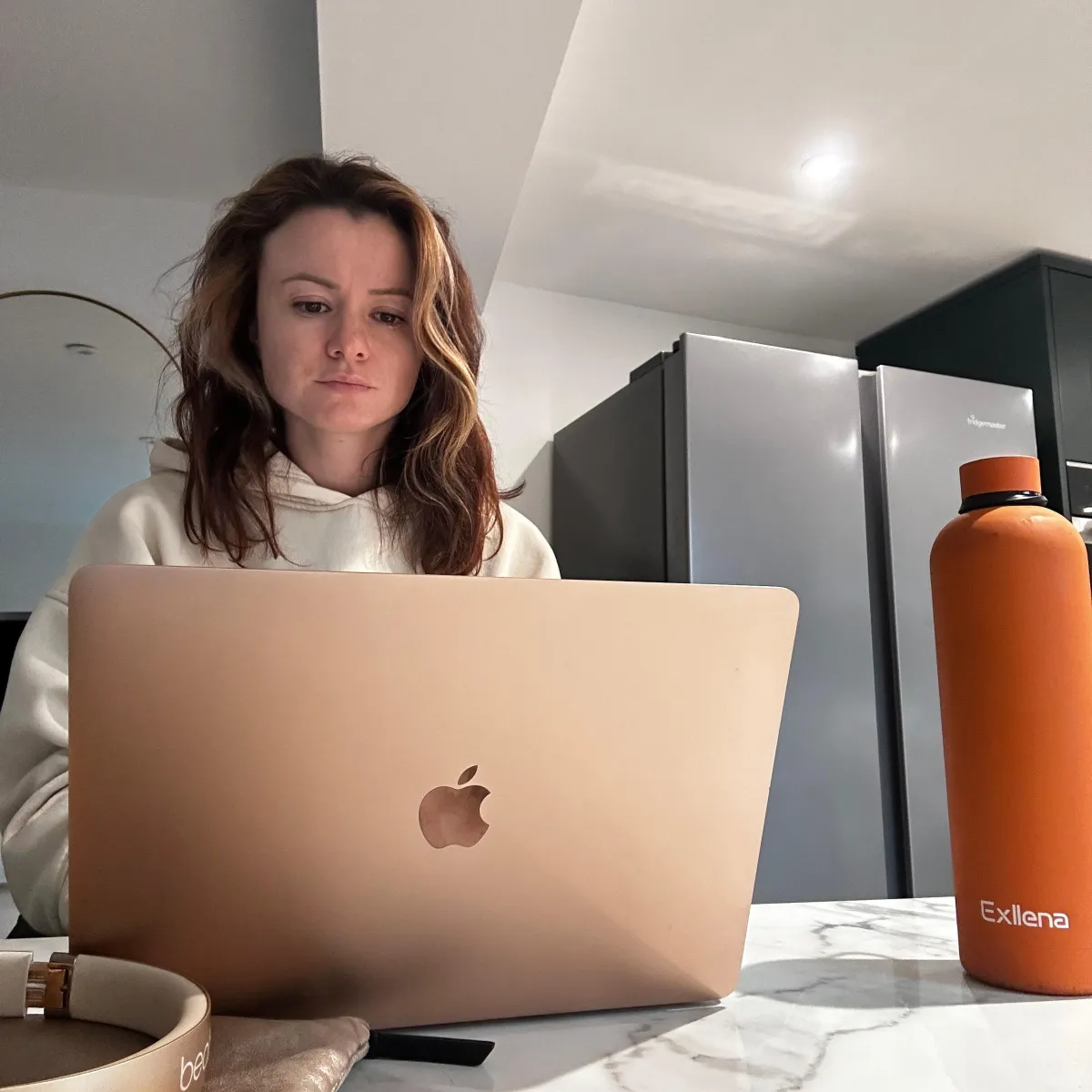 Evie, an online coach, on her laptop helping her online clients achieve their goals.