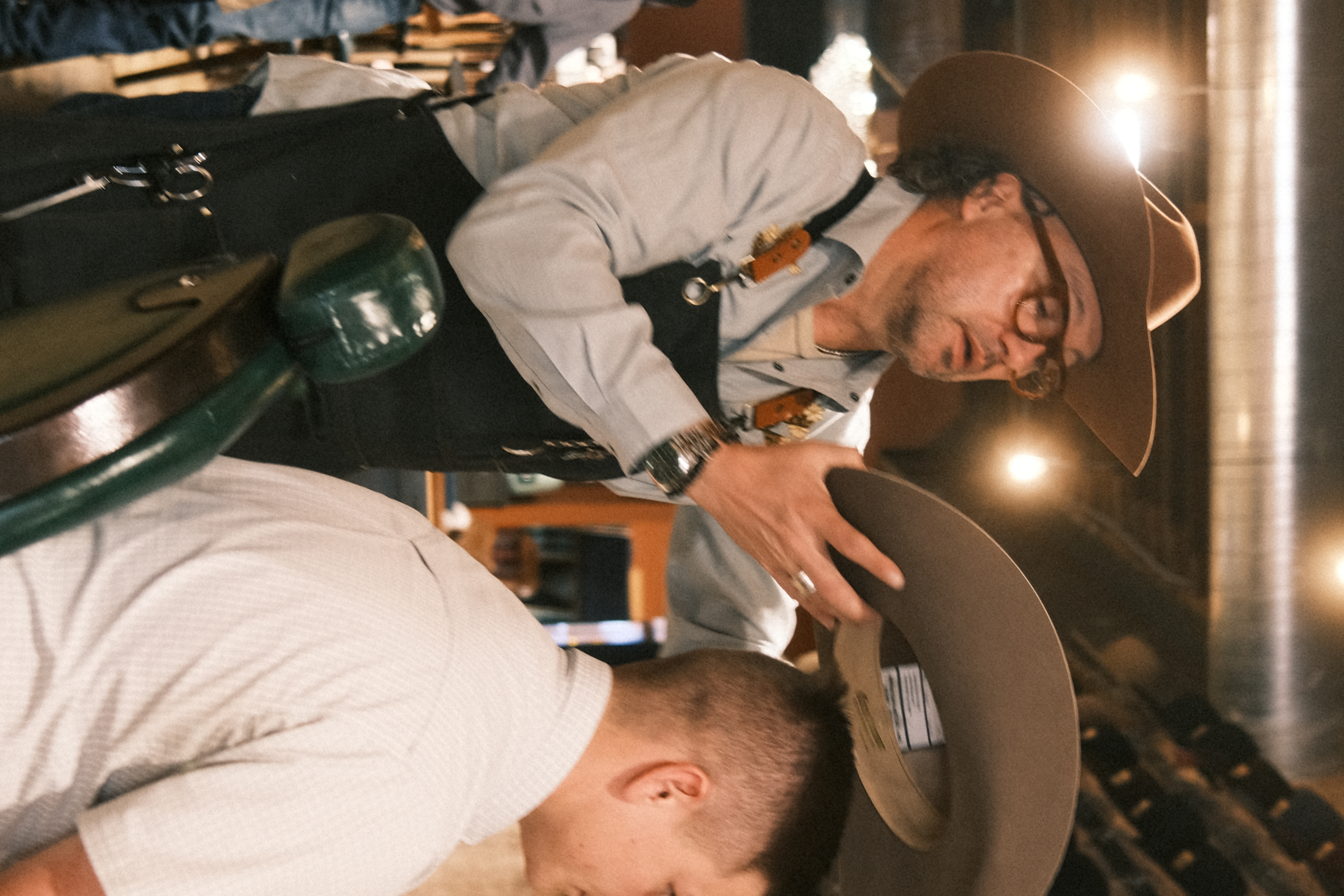 Trent Johnson of Greeley Hat Works fitting a custom hat at Walker's Western Store