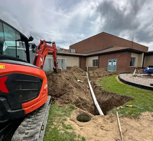 Drainage system installation with culvert and erosion control on a cleared building site