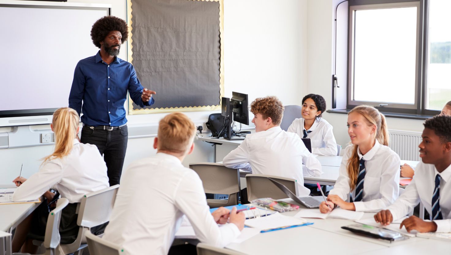teacher teaching a class of computer science students