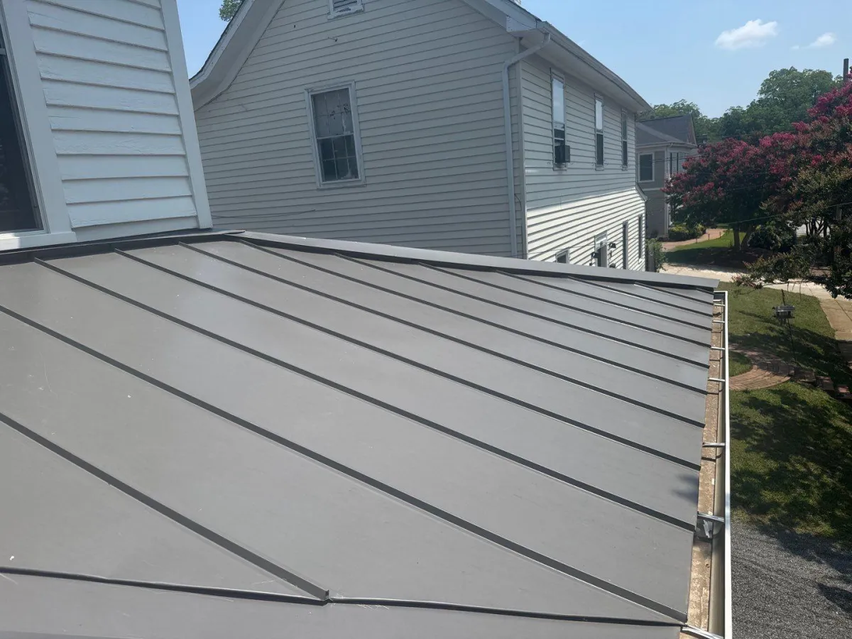 a man working on a roof with a power drill