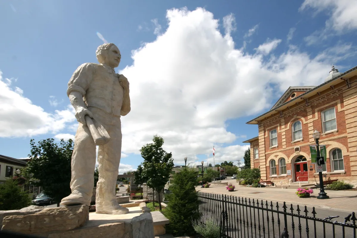 Statue of Orange Lawrence with Orangeville town hall in the background on Broadway in Downtown Orangeville