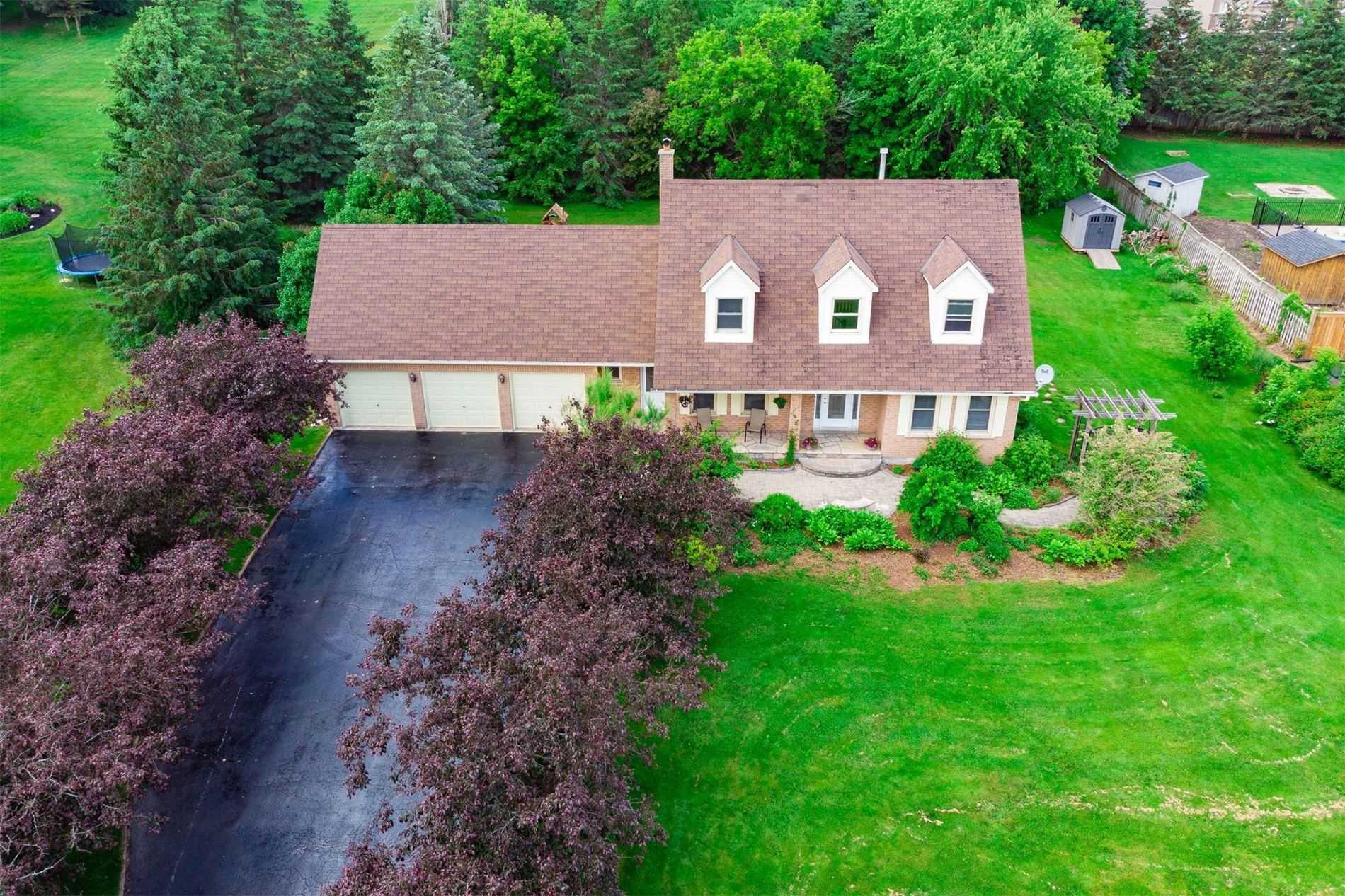 Two-storey home with attached three-car garage with spacious driveway and lawn located in Cardinal Woods, Mono