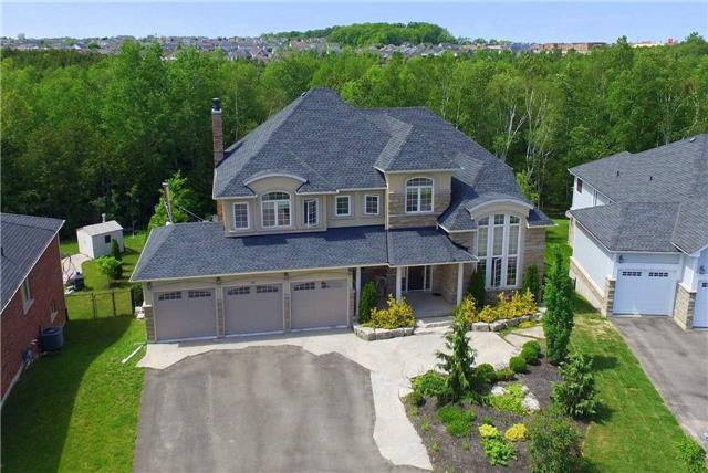 Two-storey home with attached three-car garage with spacious driveway and lush garden located in Credit Springs Estates, Orangeville