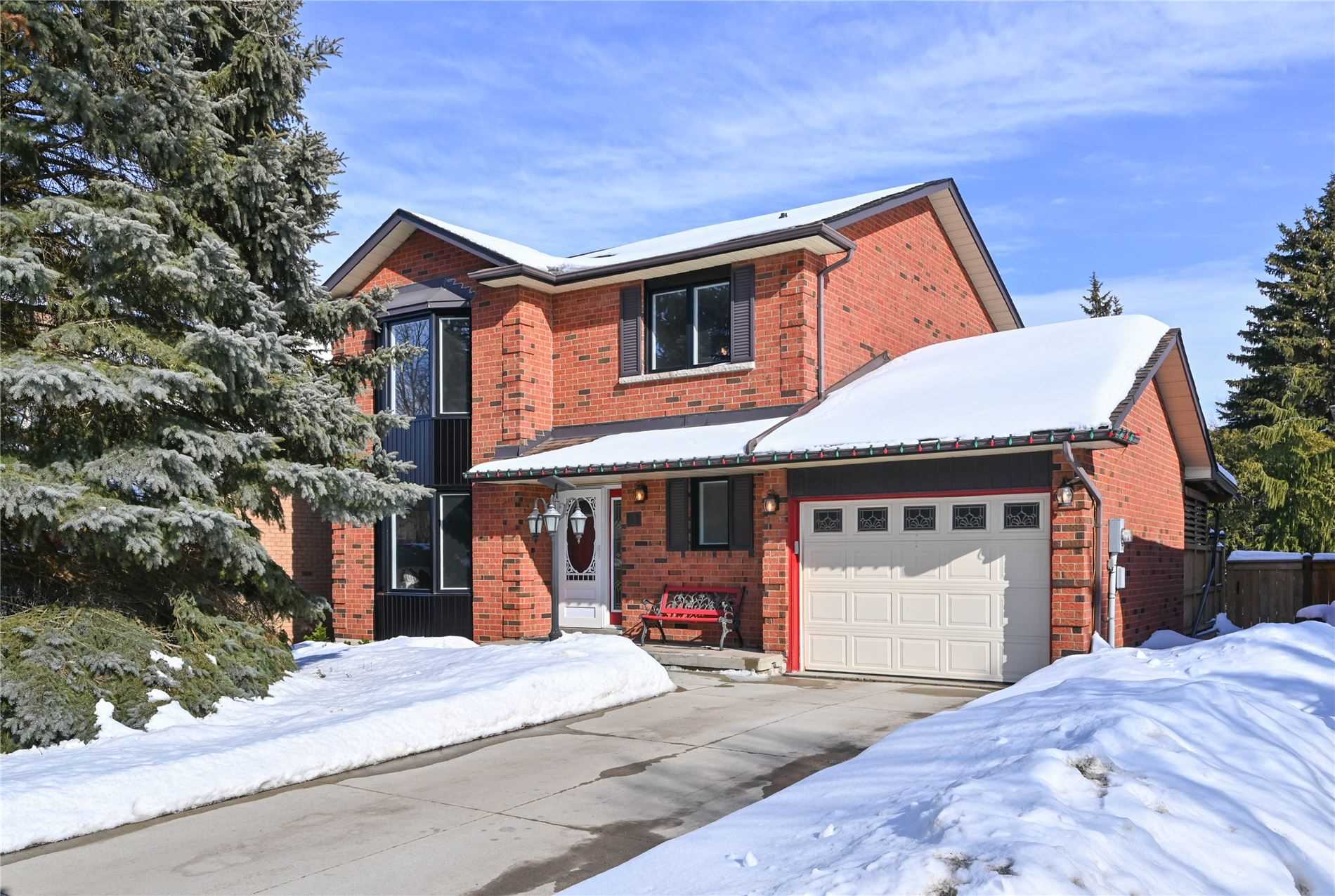 Two-storey red-brick home with attached garage, in the Kin Corner neighbourhood of Orangeville