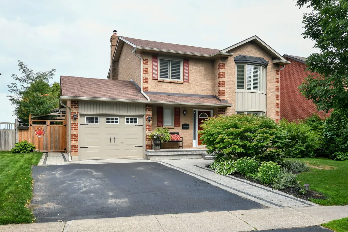 Two-storey light brown all-brick home with attached garage, in the Kin Corner neighbourhood of Orangeville