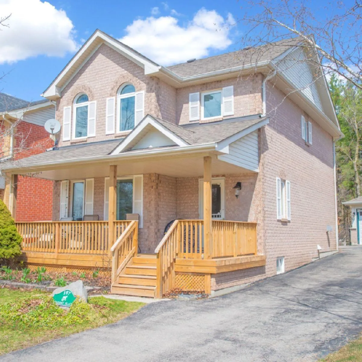 2-storey pink brick home with large front porch located in Rockwood