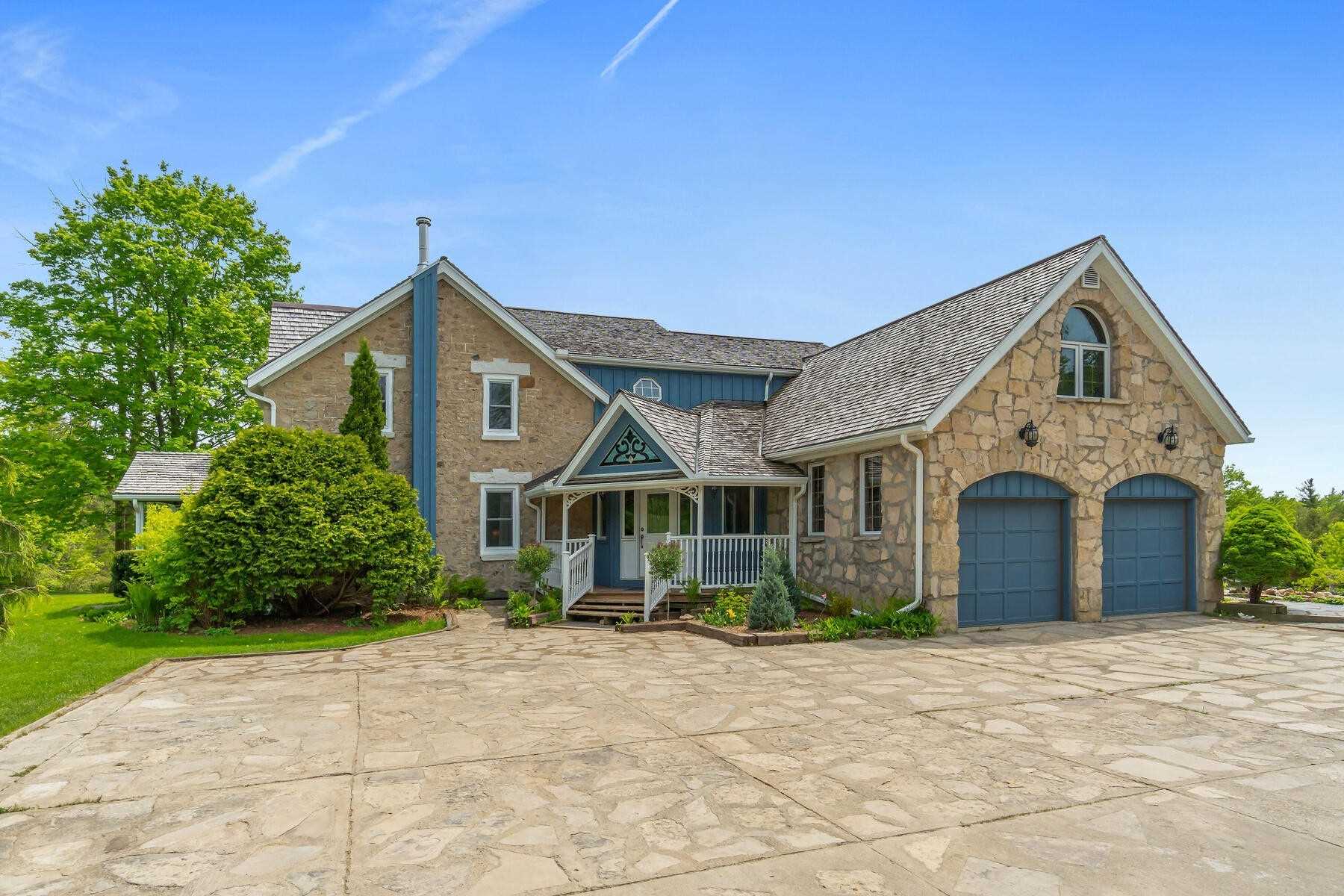 Large stone 2-storey home with attached 2-car garage located in Erin, Ontario