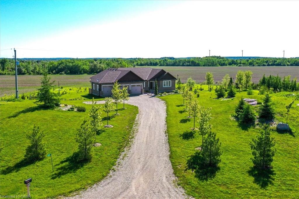 Image of a Bungalow with attached 3-car garage surrounded by farmland located in Amaranth, Ontario