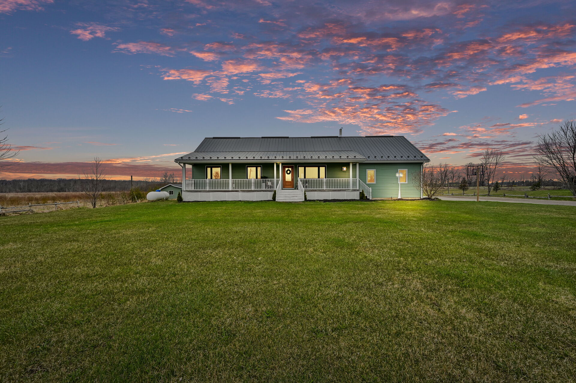 Bungalow country home with wrap around porch on large country property located in Southgate, Ontario
