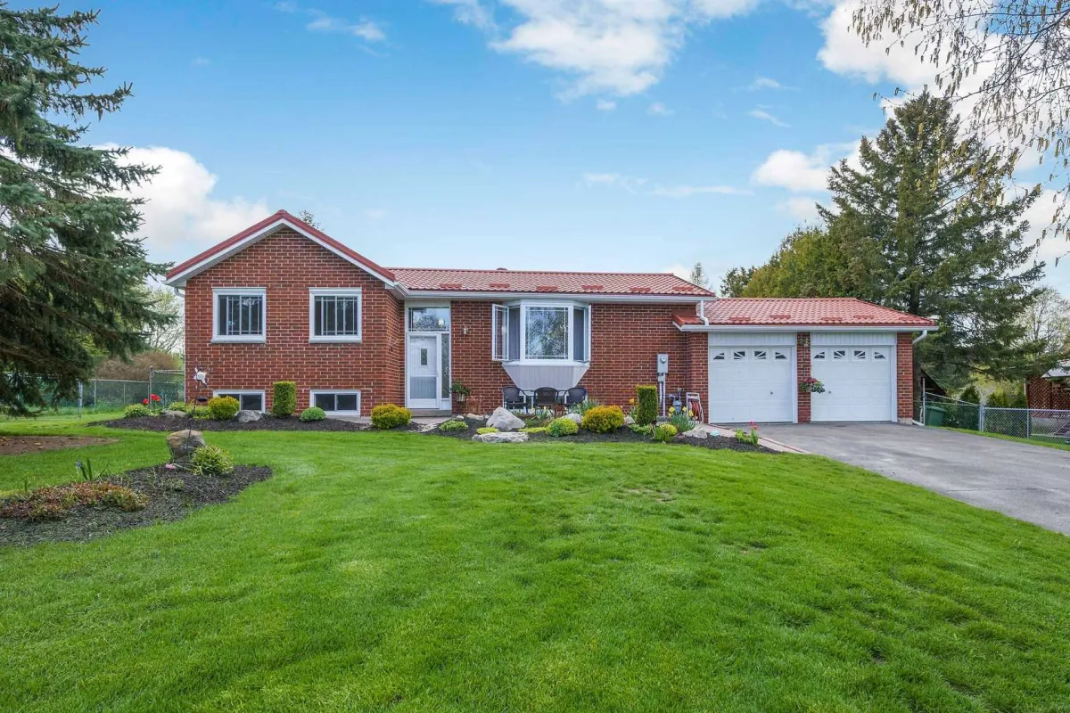 Detached red brick bungalow with attached 2-car garage located in Alton, Ontario
