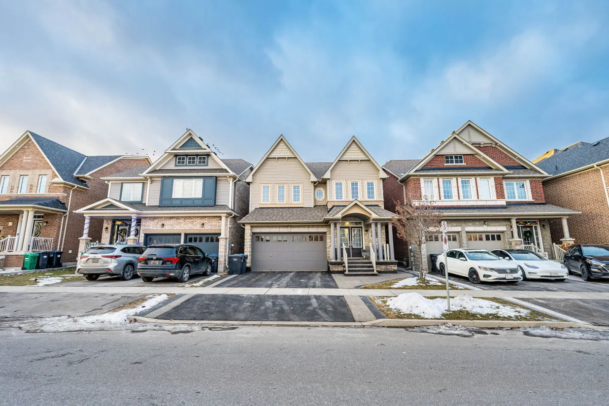 Image of a residential street located within Mayfield West, Ontario showing 4 detached 2-storey homes with attached garages