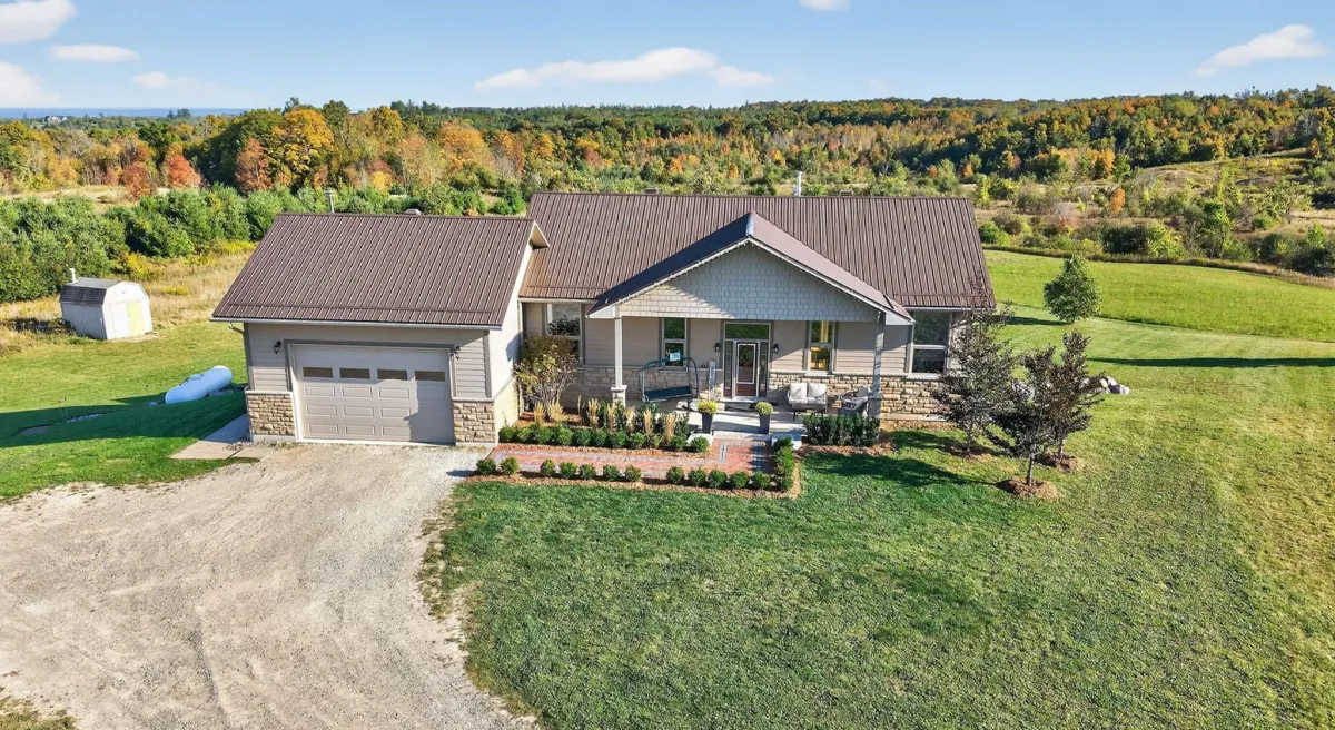 Bungalow style country home with attached garage in the Earnscliffe area of Mulmur Township