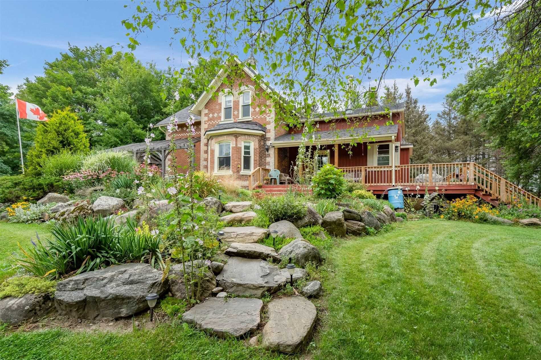 Beautiful country century home with rock garden in the Violet Hill area of Mulmur Township