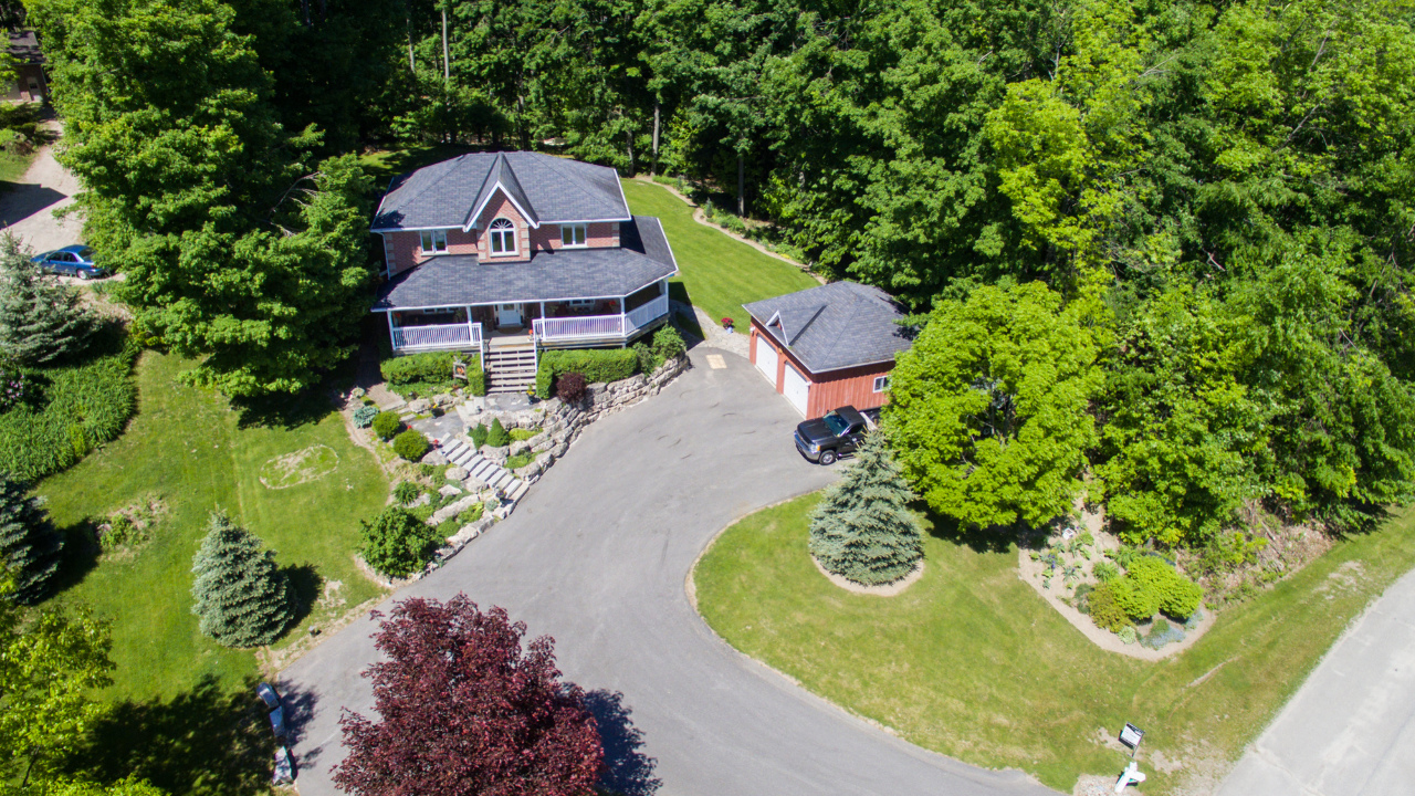 2-storey country home with wrap around veranda and detached 2-car garage located in the Mansfield area of Mulmur Township