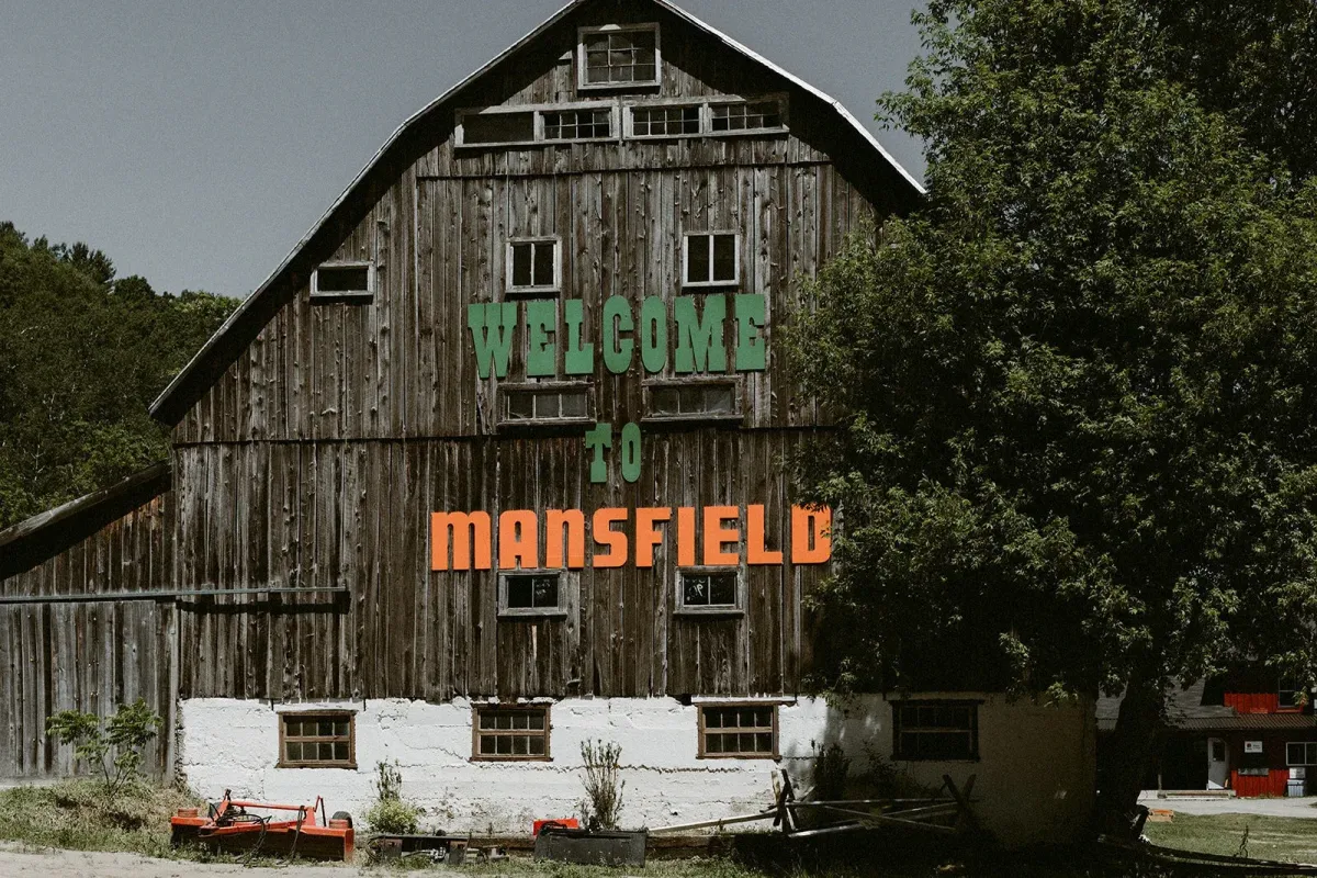 Image of the Welcome to Mansfield sign located at the Mansfeld Outdoor Centre in Mulmur Township