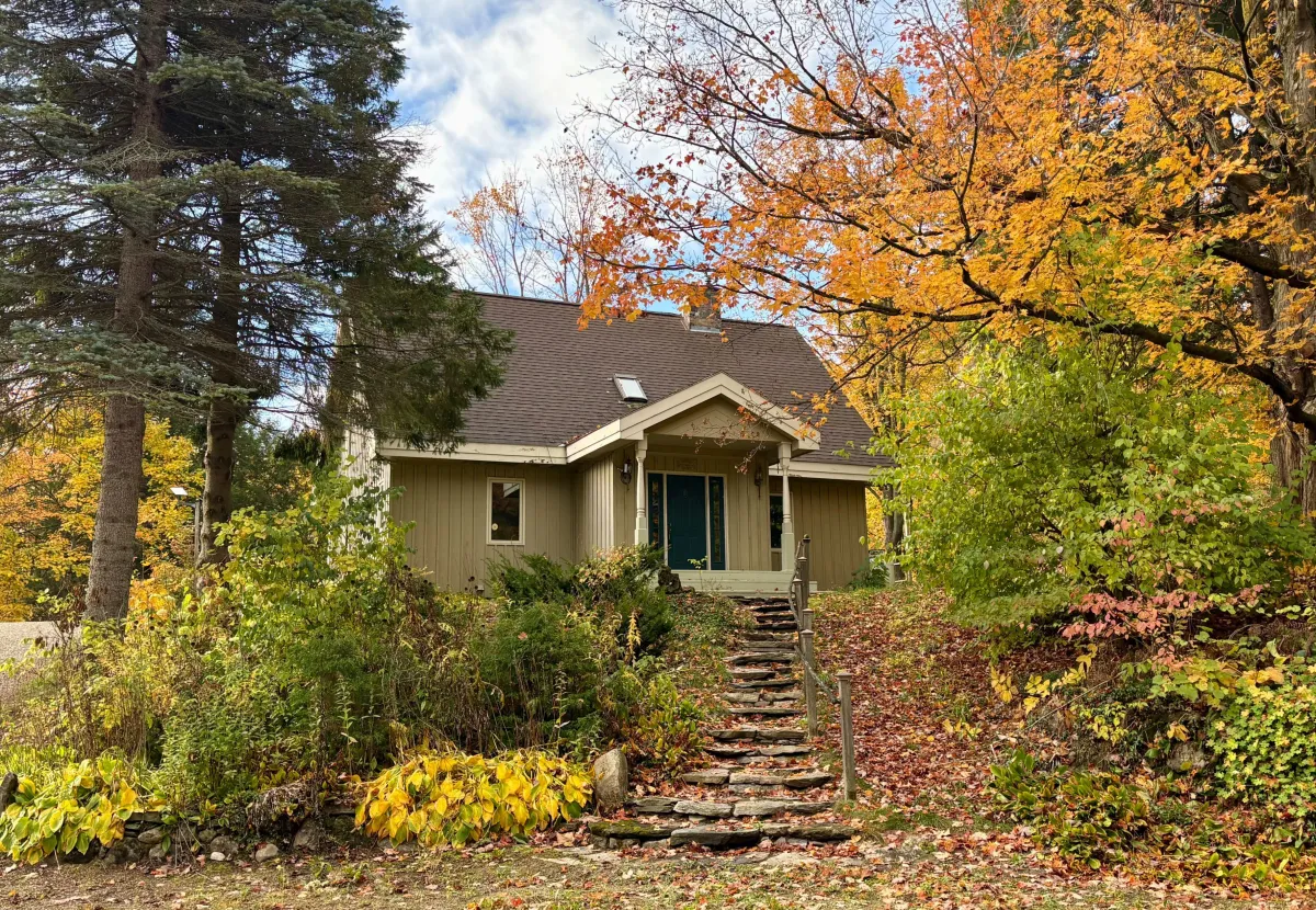 Quaint country home surrounded by autumn leaves located in the Whitfield area of Mulmur Township