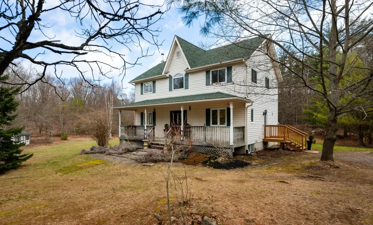 2-Storey farmhouse with covered front veranda located in the Terra Nova area of Mulmur Township