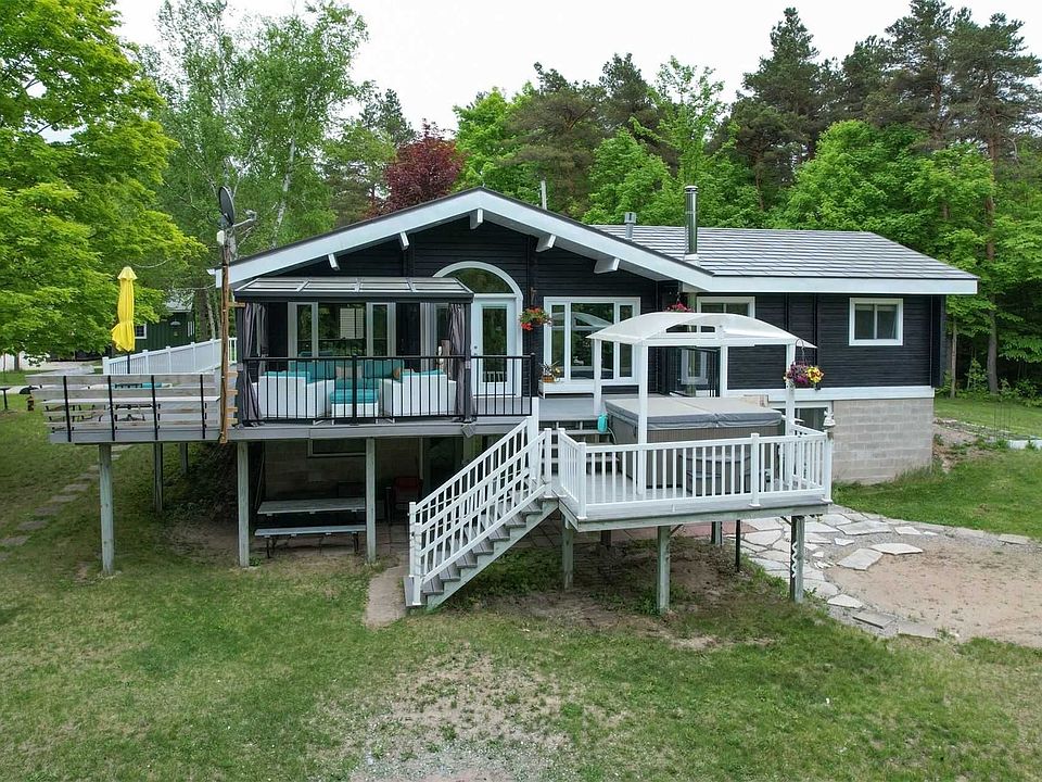 Raised bungalow with wrap-around veranda and walk-out basement located in the Randwick area of Mulmur Township