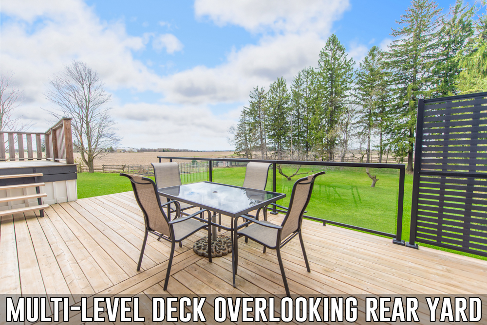 Multi-level deck overlooking rear yard located at 586274 County Road 17, Mulmur