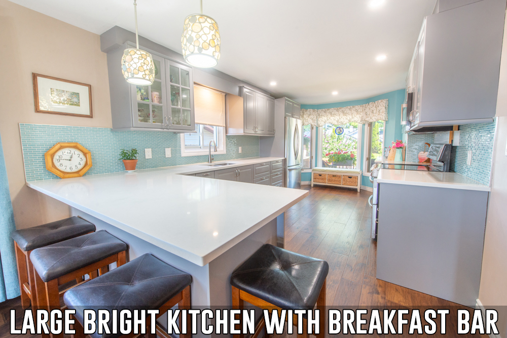 Large bright kitchen with breakfast bar at 153 Oneida Place in Kitchener