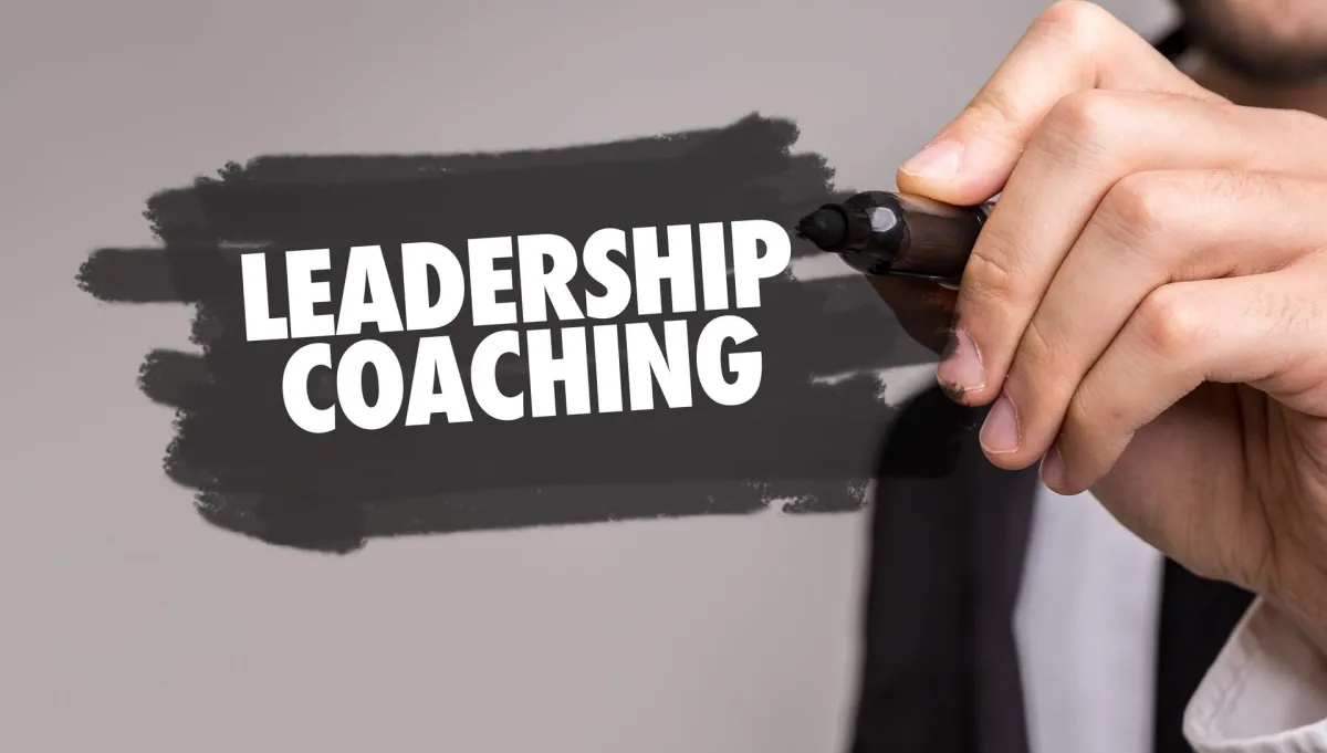 a guy making a leadership coaching sign