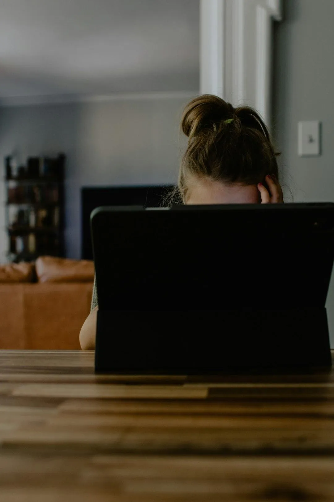 woman feeling overwhelmed looking at computer