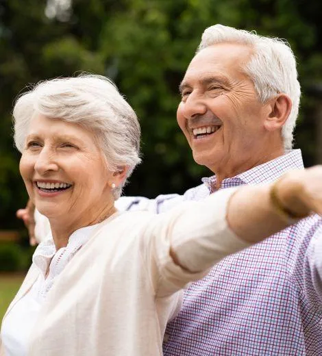 Image of senior couple smiling and exercising