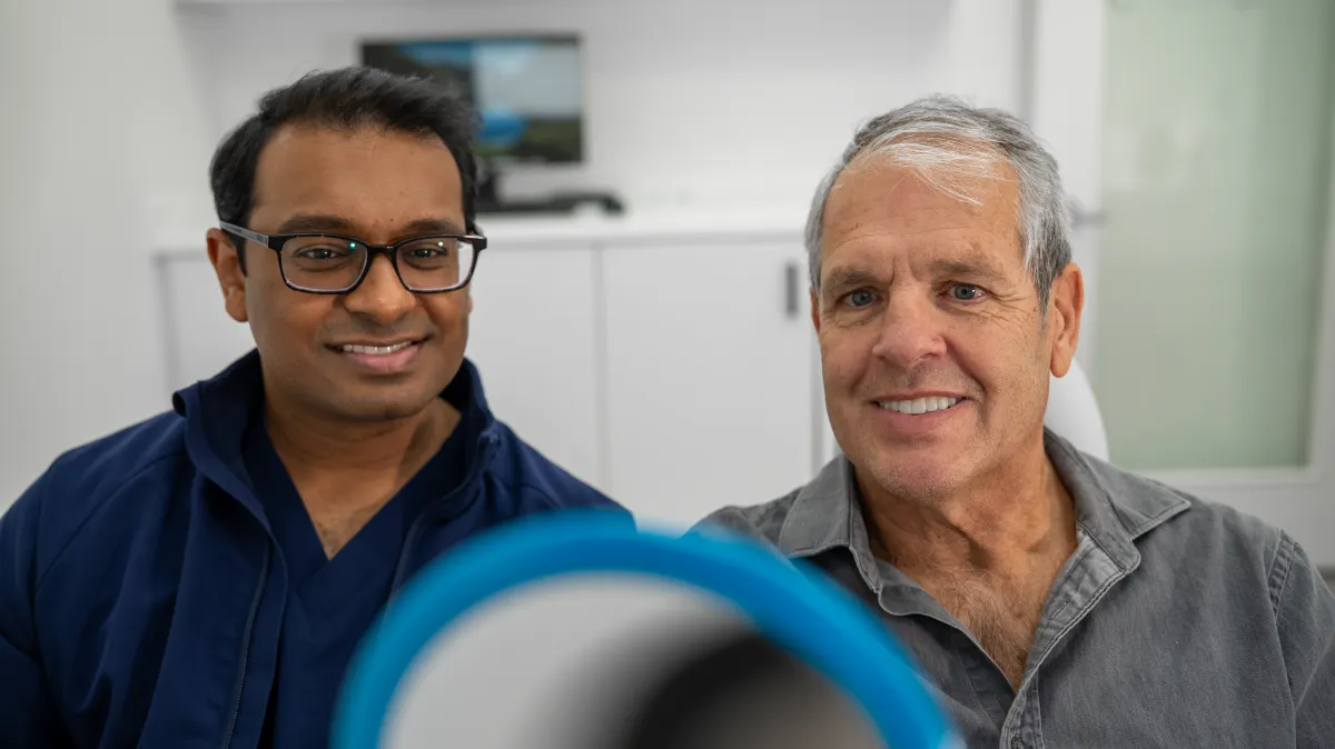 Patient smiling after All-on-X dental implants at State of the Art Dental Group Rockville