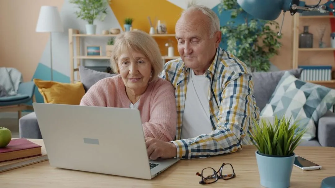 Doctor consulting patient via video call on laptop.