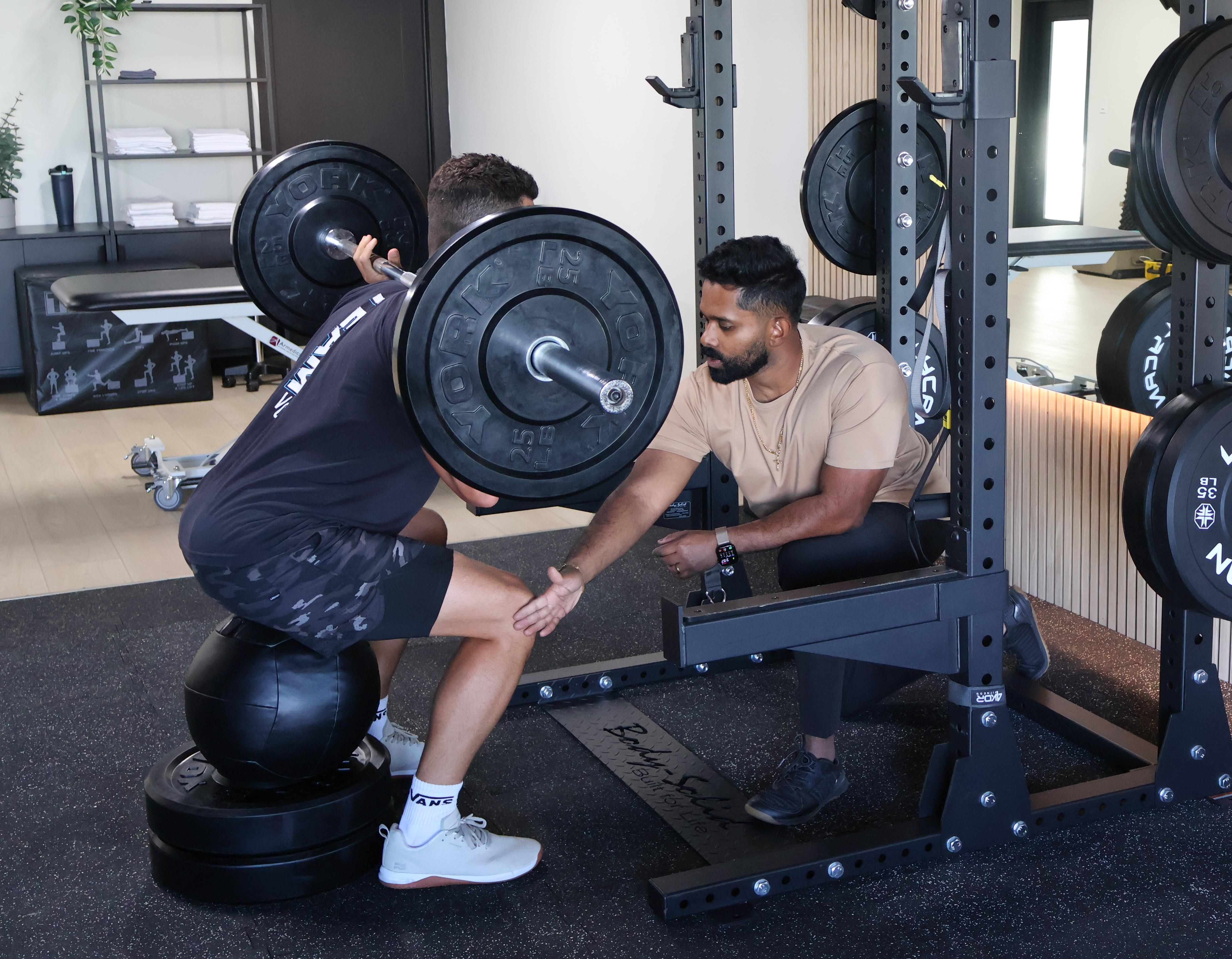 Physical therapist assessing form. 