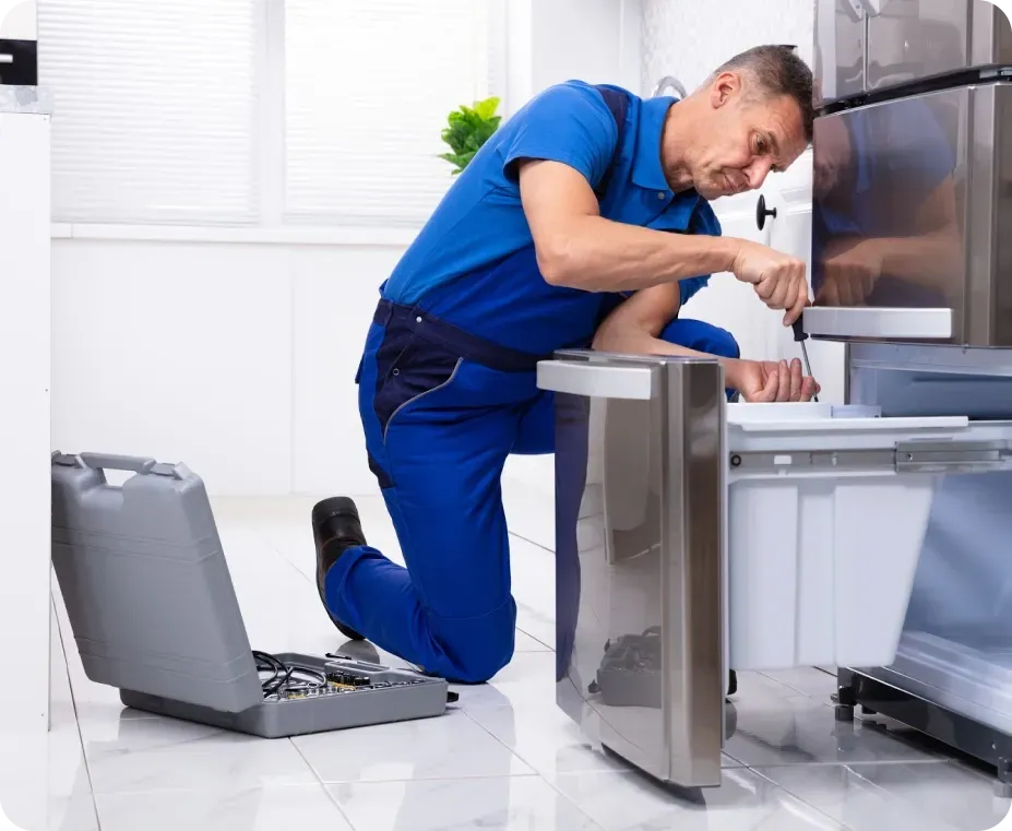 Technician repairing a dishwasher that will not drain