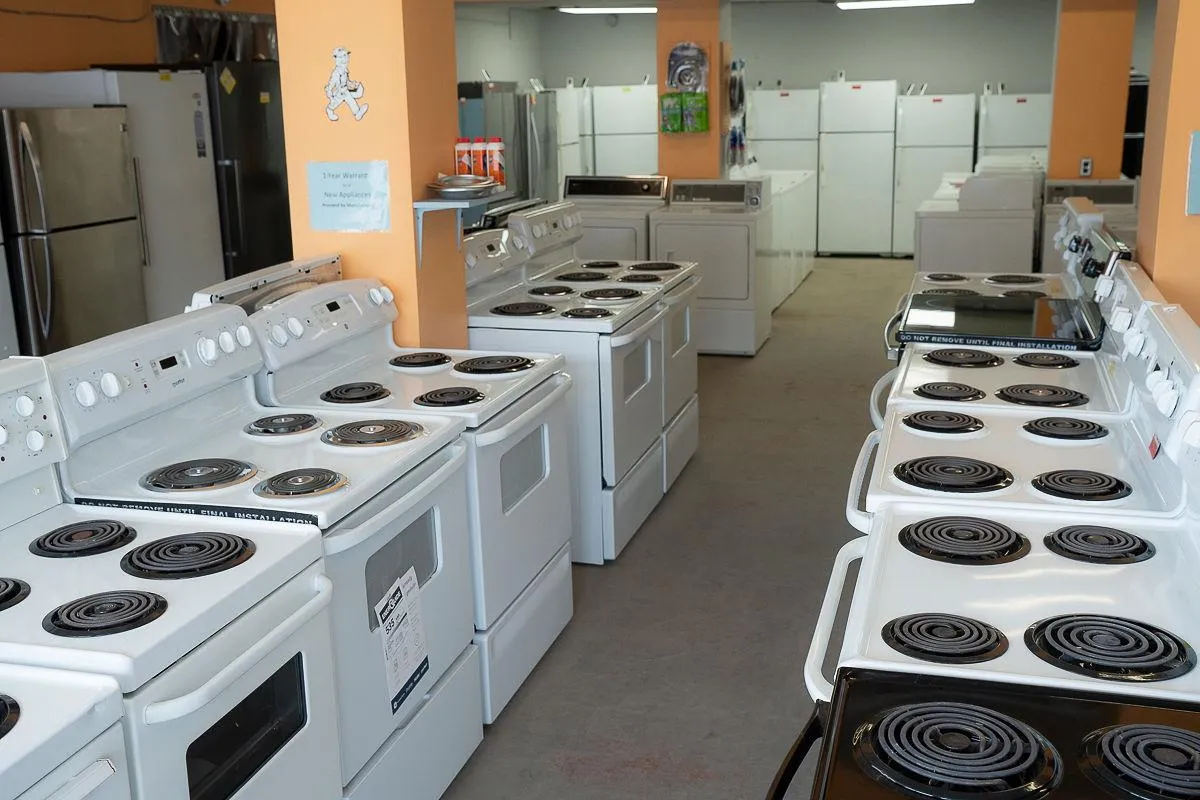 Rows of used stoves and fridges in the Al's Appliance showroom