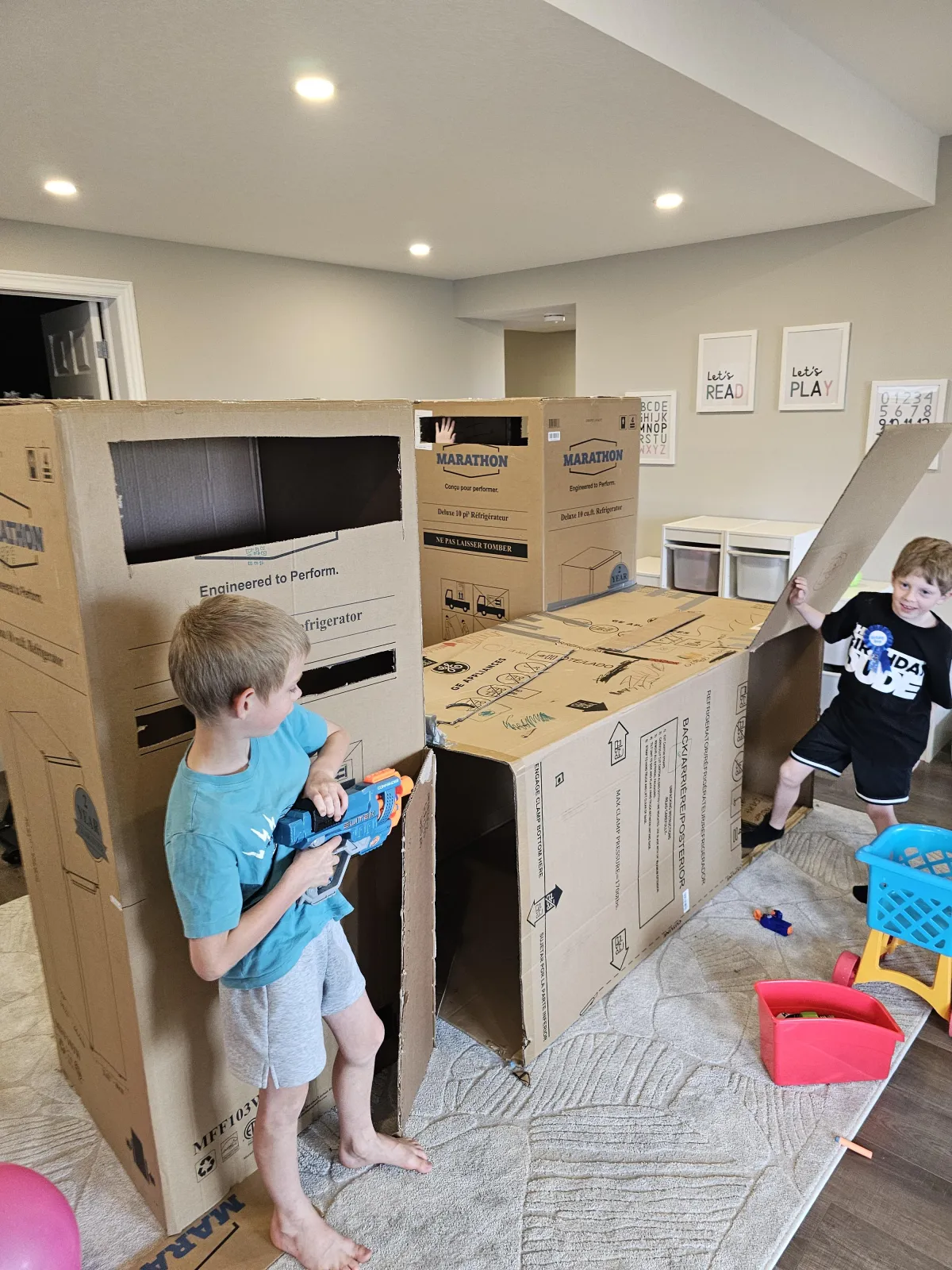 Kids playing in appliance boxes on moving day