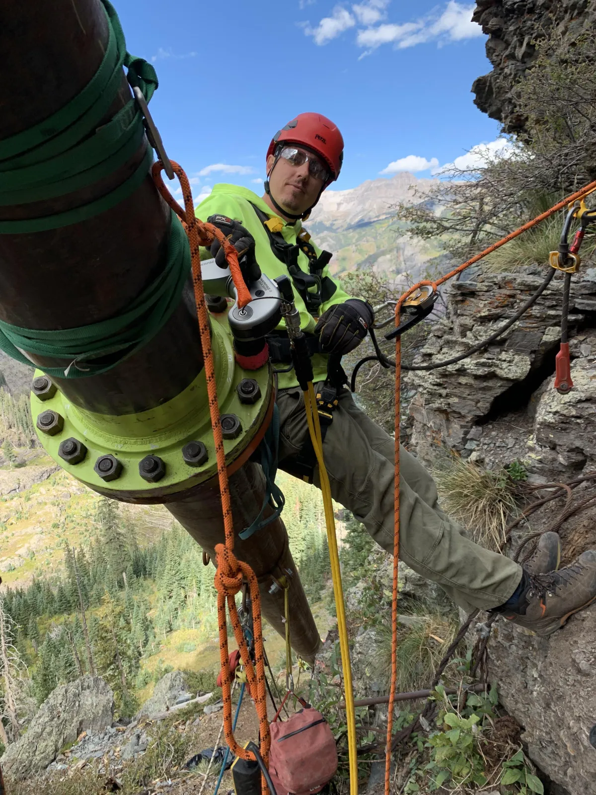 Neve Savelli performing technical rope-access work on a mountainside in Telluride
