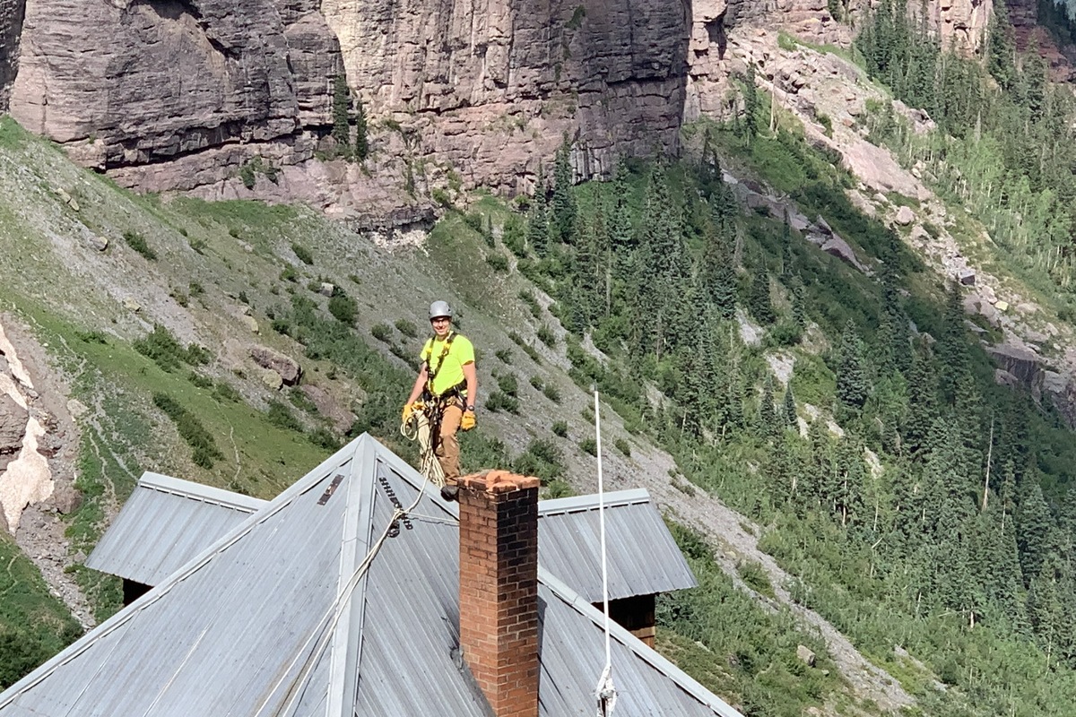 Roofing contractor working on a metal roof