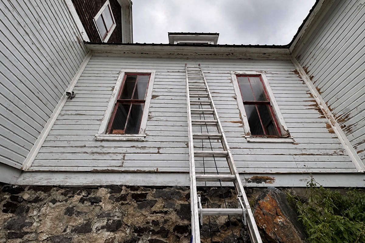 Siding contractor installing exterior home siding