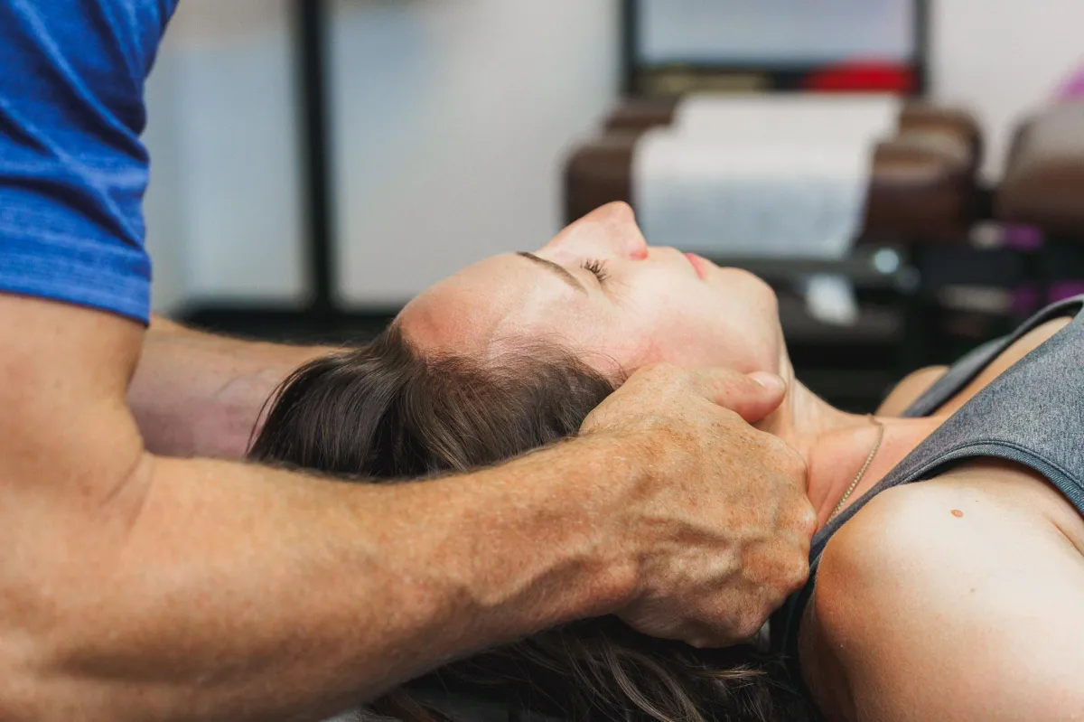Dr. Andrew Allen, Chiropractor in Wheat Ridge Colorado Adjusting Female Neck